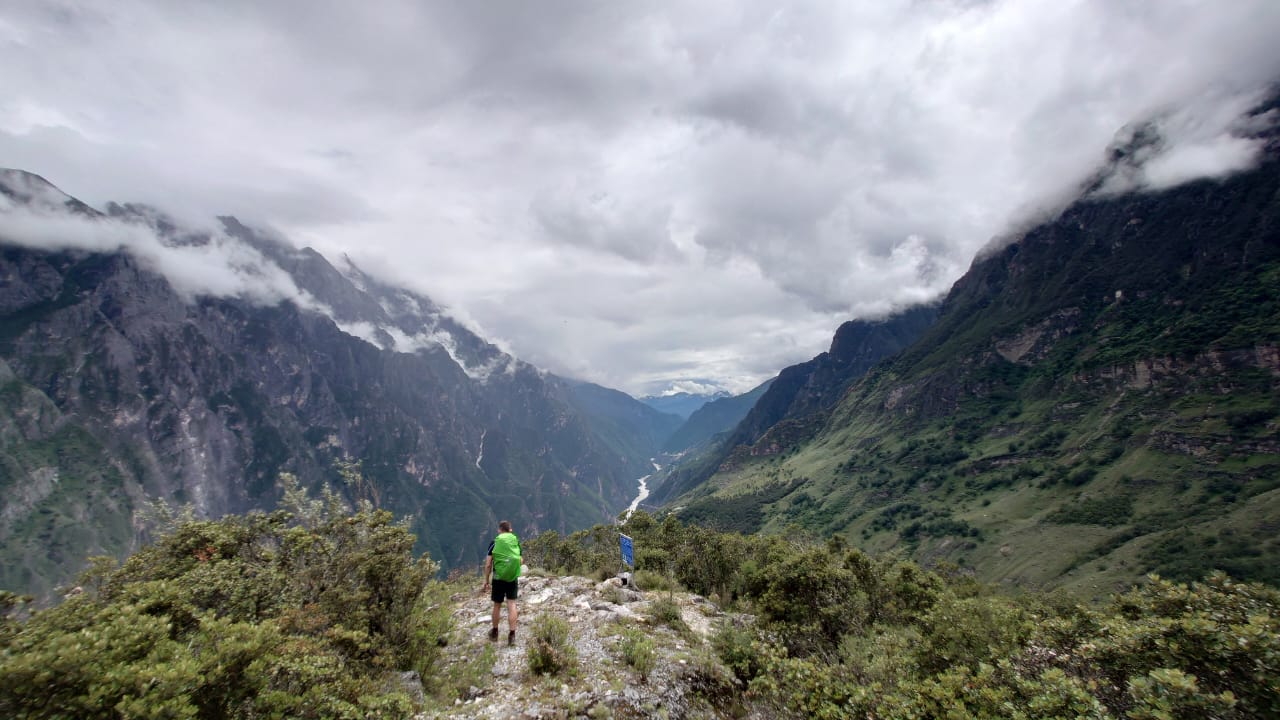 Standing on a cliff in Lijiang, China.